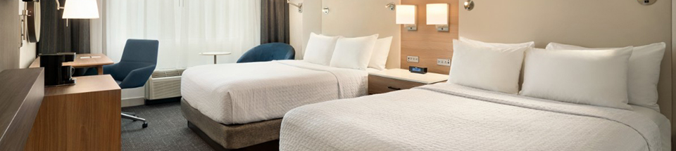 Two double beds in hotel guestroom